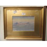 A framed and glazed watercolour of coastal scene signed bottom left E.