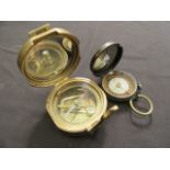 Two brass compasses