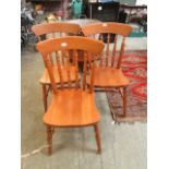 Three modern pine spindle back dining chairs