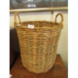 A wicker twin handled laundry basket