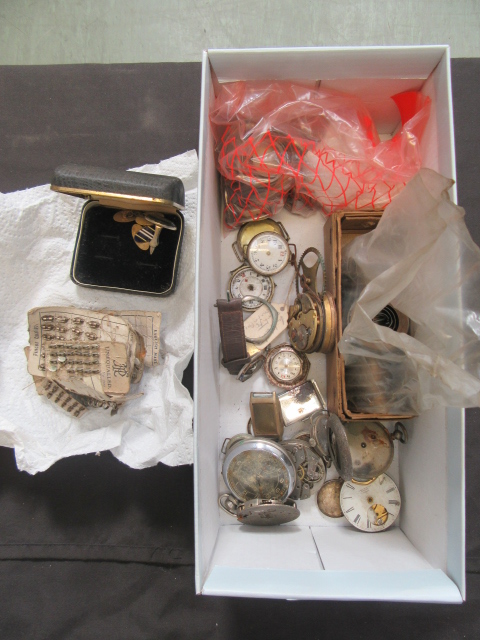 A box containing an assortment of watch parts