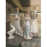 Two Lladro figures of ladies along with a girl holding a cat and a goose