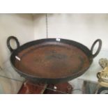 A large metal two handled pan
