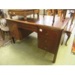 A mid-20th century twin pedestal desk