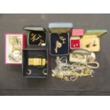 A tray containing a quantity of costume jewellery to include cuff links, brooches, watches,