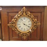 A reproduction gilt framed wall clock CONDITION REPORT: The movement in this clock