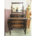 A mid-20th century oak dressing chest having swing mirror to back