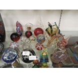 A selection of coloured glass animals, paperweights, a Waterford glass carriage clock, etc,