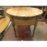 A mid-20th century circular topped oak sewing box