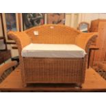 A child's wicker settee with under seat storage