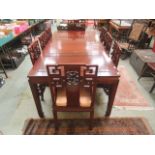 A Chinese hardwood extending dining table having two extra leaves together with a set six standard