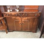 A mid-20th century oak sideboard having two drawers above cupboard doors