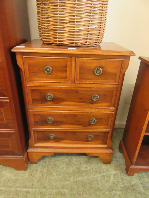 A modern yew veneered chest of two short over three long drawers