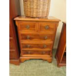 A modern yew veneered chest of two short over three long drawers