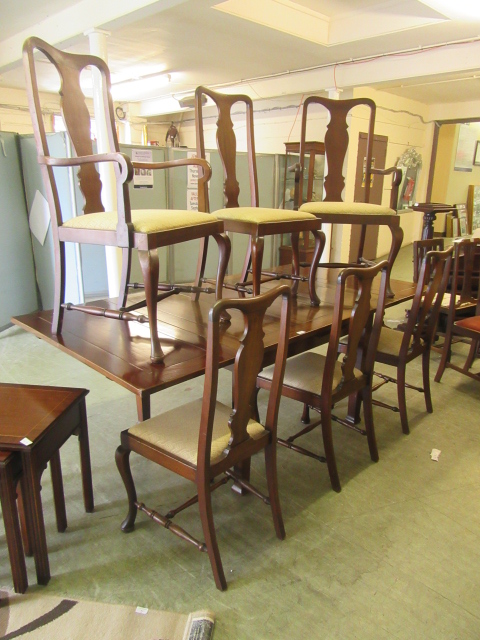 A modern mahogany extending dining table along with a set of six (four plus two) Queen Anne style