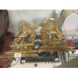 A pair of brass doorstops in the form of lions