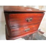 An oak and mahogany two drawer chest