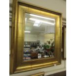 A reproduction gilt painted bevel glass wall mirror