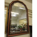 A reproduction arch top bevel glass wall mirror