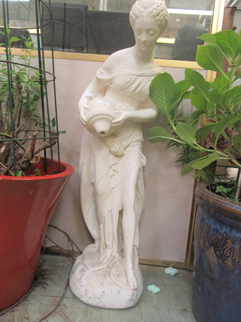 A painted concrete statue of young maiden