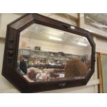 A mid-20th century oak framed bevel glass wall mirror