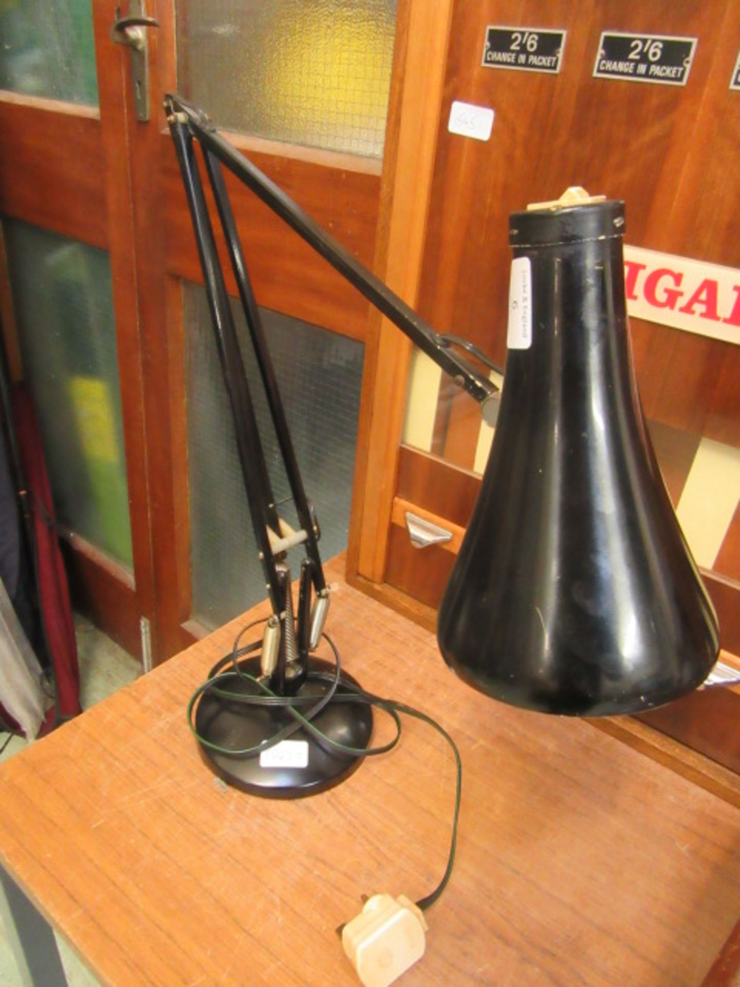 A black angle-poise style lamp