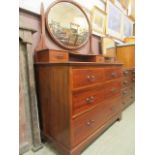 An Edwardian mahogany inlaid dressing chest having swing mirror to back the base having two small