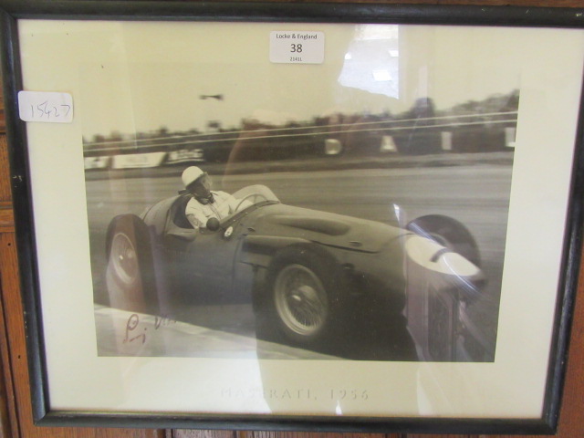 A framed and glazed print of Sterling Moss signed bottom left