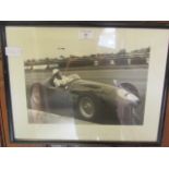 A framed and glazed print of Sterling Moss signed bottom left