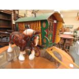 A hand crafted wagon together with a ceramic shire horse