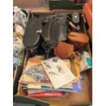 A tray containing binoculars, cameras etc.
