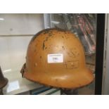 A military style tin helmet