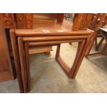 A nest of three mid-20th century teak occasional tables
