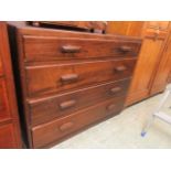 A mid-20th century chest of four graduated drawers