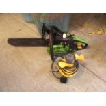 A petrol chainsaw together with a steam cleaner