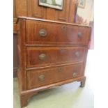 A mid-18th century small walnut and oak chest of three drawers