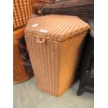 A gold painted Lloyd Loom linen basket
