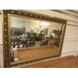 An ornate gilt framed wall mirror