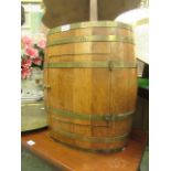 A banded oak barrel converted to drinks cabinet