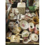 Two trays of decorative ceramic ware to include teapots, vases, mugs etc.