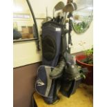 A blue canvas golf bag together with an assortment of clubs and golf shoes