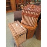A wicker basket together with a bamboo stool and a woven picnic basket