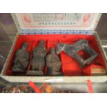 A box containing oriental carved figures and horse