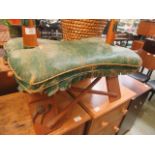 A green leather upholstered camel stool