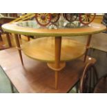 A mid-20th century circular glass topped teak table