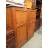 A mid-20th century oak two door gentlemen's wardrobe