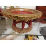 An eastern style gilt and red painted stand