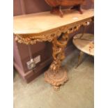 A simulated marble effect gilt cherub design console table