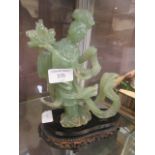 A jade style carved eastern style figure on stand