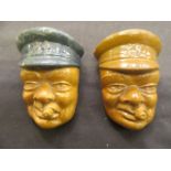 Two carved stone brooches in the form of Winston Churchill